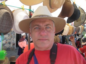 Tony tries on a traditional Panama hat at a street market.