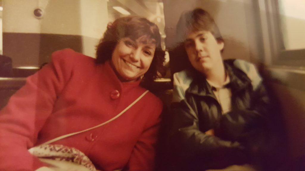 Mom and Rodrigo on the train for sightseeing in NYC, 1985.